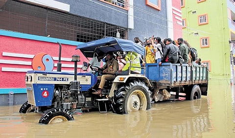 Student residing in Dhulapally being evacuated in a tractor on Tuesday. (Photo | Express)