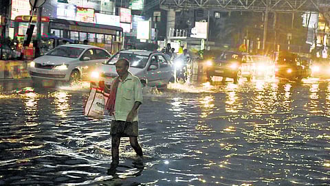 A man wading through rainwater;Prasant Madugula