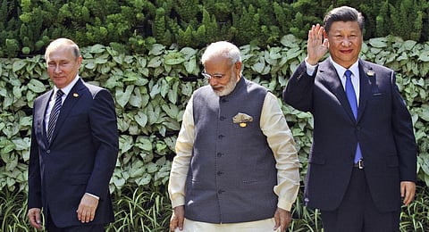 FILE- Prime Minister Narendra Modi, Russian President Vladimir Putin and Chinese President Xi Jinping stand at the start of the BRICS Summit in Goa, India, Oct. 16, 2016. (Photo | AP)