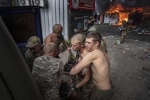Ukrainian soldiers move to the ambulance an injured woman after a Russian rocket attack on a food market in the city center of Kostiantynivka, Ukraine, Wednesday, Sept. 6, 2023. (AP)