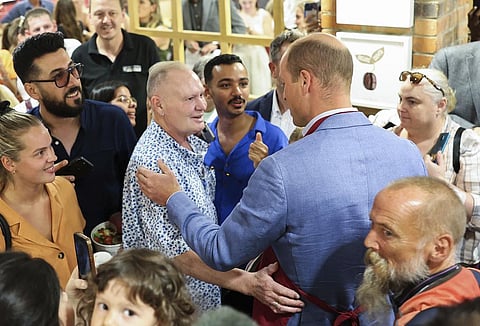 The Prince of Wales, right, greets Paul Gascoigne, left, during a visit to a Pret A Manger store in Bournemouth (Photo | AP)