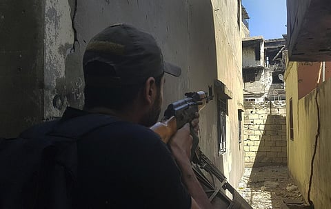 A fighter of the Palestinian Fatah group takes his position during clashes with Islamist militants in the Palestinian refugee camp of Ein el-Hilweh. (Photo | AP)