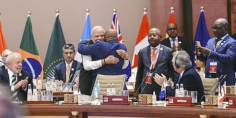 Prime Minister Narendra Modi hugs President of the Union of Comoros and Chairperson of the African Union (AU) Azali Assoumani during the G20 Summit 2023 at the Bharat Mandapam | PTI