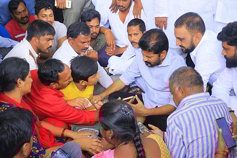 TPCC chief A Revanth Reddy consoling the family members of home guard Ravinder, who died while undergoing treatment in OGH on Friday. (Photo | Vinay Madapu)