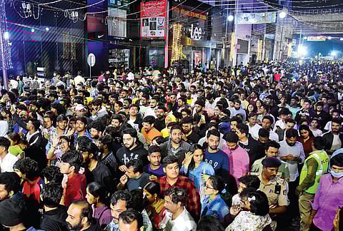 A sea of people gathers on Brigade Road on Sunday night to usher in the New Year. Above: Police try to control the crowd | Shashidhar Byrappa, Allen Egenues J