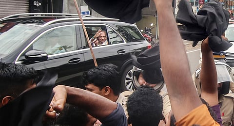 Khan waves from his car even as SFI and DYFI workers show him black flags during his visit to Thodupuzha in Idukki on Tuesday | Shiyami