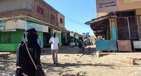 Sudanese civilians walk through a nearly empty road with many shops closed for security reasons in Gedaref city in eastern Sudan. (Photo | AP)