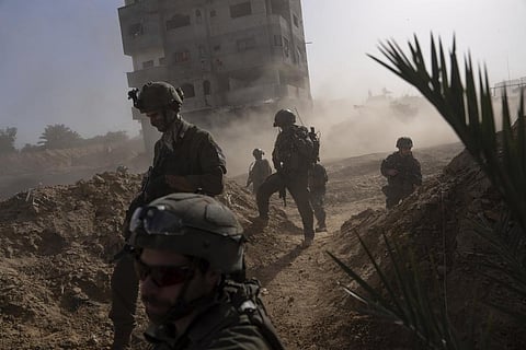 Israeli soldiers take up positions during a ground operation in Khan Younis, Gaza Strip on Wednesday, Jan. 10. 2024.