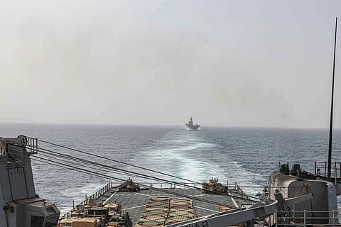 In this US Navy image, the amphibious dock landing ship in USS Carter Hall and amphibious assault ship USS Bataan transit the Bab al-Mandeb strait on Aug 9, 2023. (Photo | AP)