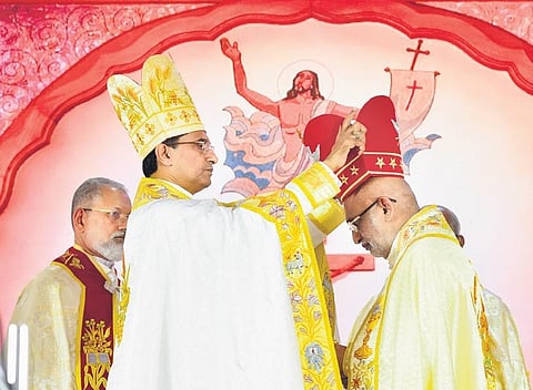 Syro-Malabar Church administrator Mar Sebastian Vaniyapurackal places the ceremonial mitre on Major Archbishop Mar Raphael Thattil at his anointing ceremony at Mount St Thomas, Kakkanad on Thursday |