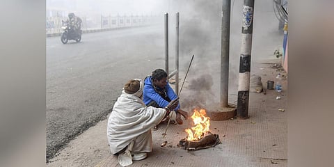 People warm themselves with a bonfire during a cold and foggy winter morning, in Patna, Friday, Jan. 12, 2024. (Photo | PTI)
