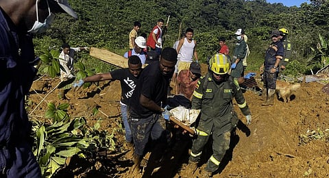 Members of the rescue teams carrying a corpse from the area of a landslide in the road between Quibdo and Medellin, Choco Department, Colombia. (Photo | AFP)