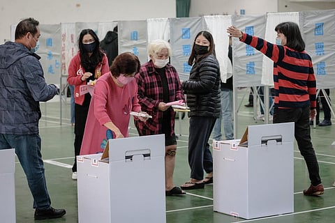 People cast their ballots to vote in the presidential election at a polling station in a high school in Tainan on January 13, 2024. (Photo | AFP)