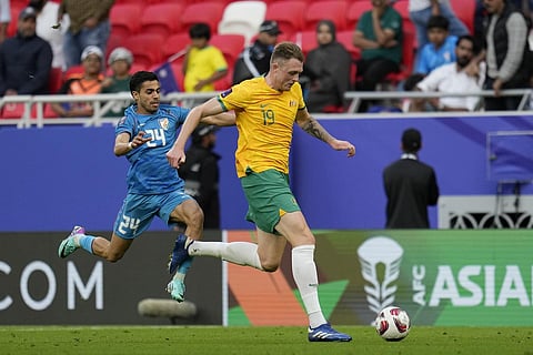 India's Vikram Partap, left, tries to stop Australia's Harry Souttar during the Asian Cup Group B soccer match against Australia at Ahmad Bin Ali Stadium in Doha, Qatar, Jan. 13, 2024. (Photo |PTI)