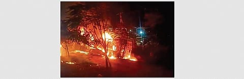 The overturned bus is seen burning near Beechupally village on Saturday.