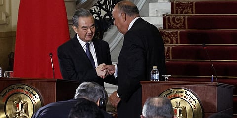 Egyptian Foreign Minister Sameh Shoukry (R) and China's Foreign Minister Wang Yi shake hands during a press conference. (Photo | AFP)