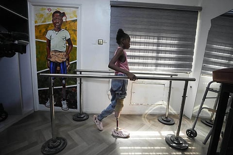 Princess Igbinosa, 10, who lost her leg following a traffic accident, tests her prosthetic limb at the IREDE foundation in Lagos, Nigeria, Nov 30, 2023. (Photo | AP)