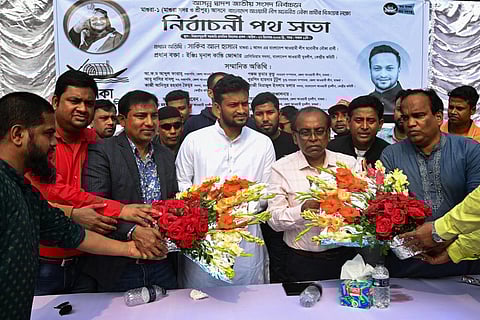 In this photograph taken on December 27, 2023, Shakib Al Hasan (C) receives flowers during a campaign rally ahead of the 2024 general elections, in Magura. (Photo | AFP)