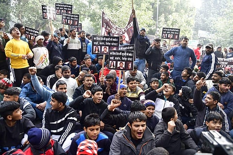 Young wrestlers hold placards during a protest against wrestlers Sakshi Malik, Bajrang Punia and Vinesh Phogat at Jantar Mantar, in New Delhi. (Photo | Parveen Negi)
