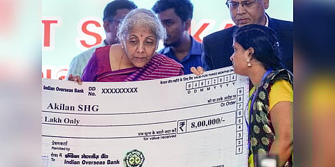 Union Finance Minister Nirmala Sitharaman hands over a cheque to a beneficiary under the Pradhan Mantri Mudra Yojana during a 'Viksit Bharat Sankalp Yatra, event, in Chennai (Photo | PTI)