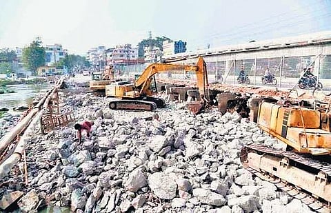 Labourers engaged in the demolition of the existing Moosarambagh bridge in Hyderabad on Wednesday | Express