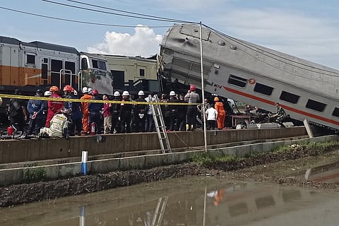 Rescuers inspect the wreckage of trains after a collision in Cicalengka, West Java, Indonesia. (Photo | AP)