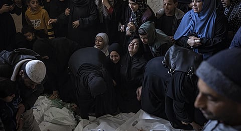 Members of the Abu Sinjar family mourn their relatives killed in the Israeli bombardment of the Gaza Strip. (Photo | AP)