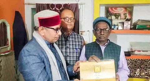 Iqbal Ansari, a litigant in the Ramjanmabhoomi-Babri Masjid case, receives an invitation for the Ram temple consecration ceremony, in Ayodhya, Friday, Jan. 5, 2024. (PTI)