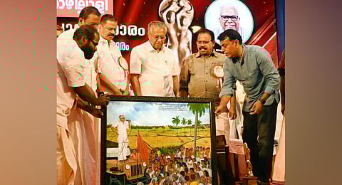 Chief Minister Pinarayi Vijayan looking at a portrait of veteran Communist leader VS Achuthanandan, during a function to award the Kerala Puraskaram. (Photo | Vincent Pulickal)