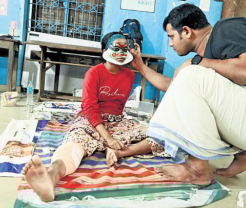 Hridya Haseen, the kathakali contestant with burns, receiving a final touch-up before her performance | Vincent Pulickal