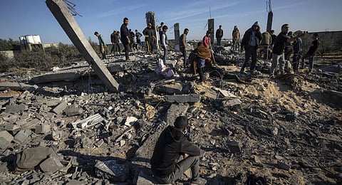 Palestinians search for bodies and survivors in the rubble of a house destroyed in an Israeli airstrike, in Rafah, southern Gaza Strip. (Photo | AP)