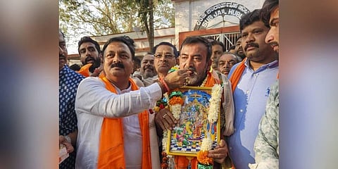 : BJP MLA Mahesh Tenginakai offers sweets to activist Srikanth Poojari after the latter was released from prison on bail. (Photo | PTI)