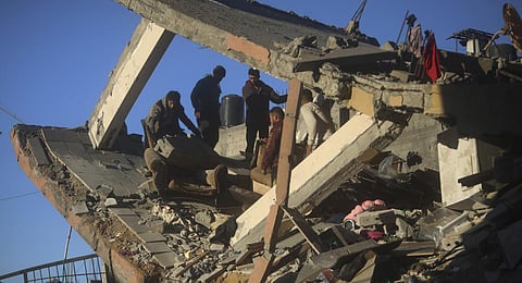 Palestinians react after their relative's home was destroyed by an Israeli airstrike in Rafah, southern Gaza Strip. (Photo | AP)
