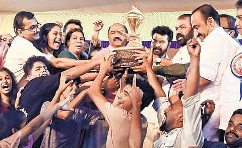 Participants and teachers from Kannur district, the winner of the 62nd State School Arts Festival, being presented the coveted gold cup. Ministers K N Balagopal and V Sivankutty, actor Mammootty and