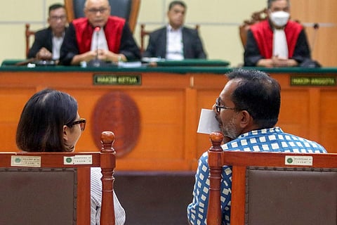 Defendants Lokataru director Haris Azhar (R) and former Kontras coordinator Fatia Maulidiyanti (L) chat during the judge's verdict at the East Jakarta district court on January 8, 2024. (Photo | AFP)