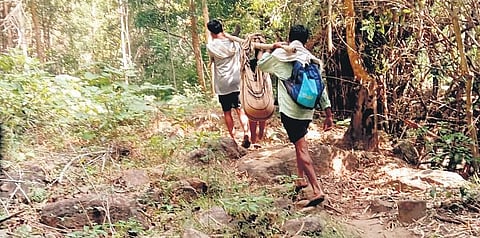 Villagers of Ramachandrapuram are carrying a sick woman and her son in a makeshift stretcher to the hospital due to a lack of proper road connectivity