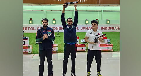 Varun Tomar (centre) celebrates after winning the top prize in the men's 10m air pistol event of the ongoing Asian Championship in Jakarta.