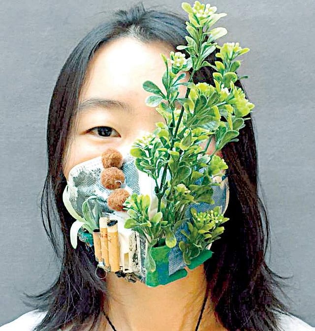 A participant displays her creatively decorated mask