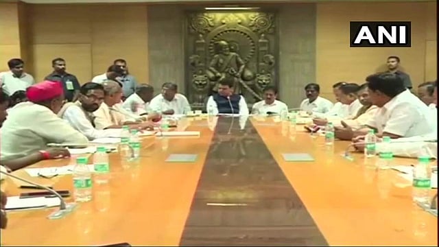 Maharashtra Chief Minister Devendra Fadnavis holds <g class=