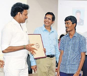 Minister Anbil Mahesh Poyyamozhi giving admission letter to a student | R Satish Babu