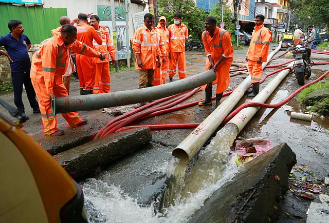Fire and rescue personnel pump out flooded water from KSRTC bus stand's premises at Mullassery canal road in Kochi, Kerala, on July 31, 2022. (Photo | TP Sooraj, EPS)
