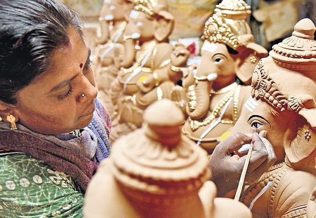 As Ganesha festival nears, an artist gives finishing touches to an idol at Pottery Town in Bengaluru on Tuesday | Vinod Kumar T