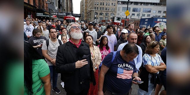 People gather on Cedar Street by the perimeter of the commemoration ceremony during a moment of silence on the 21st anniversary of the September 11, 2001 terror attacks. (Photo | AP)