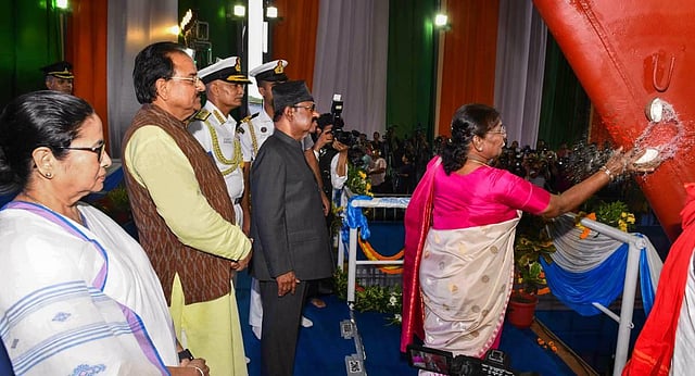 President Droupadi Murmu breaks a coconut during the launch ceremony of Vindhyagiri, the sixth ship of project 17A of Indian Navy. (Photo | PTI)