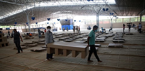 Workers carry cardboard beds after assembling as they prepare a facility that can accommodate more than ten thousand COVID-19 patients at the Radha Soami Satsang Beas complex in the Chattarpur area of New Delhi on Wednesday. (Photo | Shekhar Yadav/EPS)