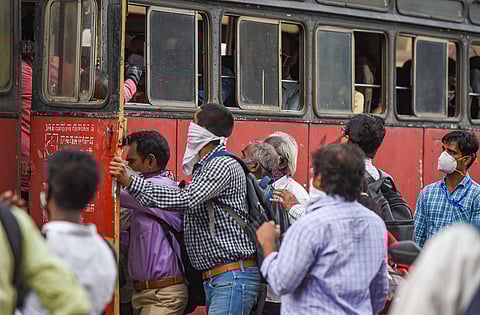 Commuters, not adhering to social distancing norm, board a bus during ongoing COVID-19 lockdown, at Chhatrapati Shivaji Maharaj Terminus in Mumbai. (Photo | PTI)