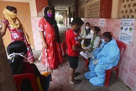 Community health workers screen people for COVID-19 and Malaria symptoms at a school in Dharavi, one of Asia's biggest slums, in Mumbai, India, Wednesday, Aug. 19, 2020. (Photo | AP)