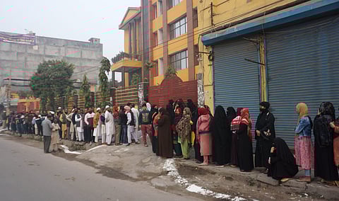 Voters wait in a queue to cast their votes for the Municipal Corporation of Delhi (MCD) elections 2022. (Photo | PTI)