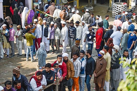 Citizens wait to cast their vote at a polling booth, during the first phase of Uttar Pradesh Assembly elections, in Kairana. (Photo | PTI)