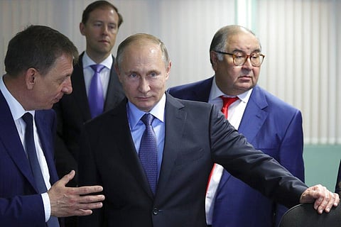 Vladimir Putin, center, listens to Lebedinsky GOK Managing Director Oleg Mikhailov, left, as businessman and founder of USM Holdings, Alisher Usmanov, right. (Photo | AP)